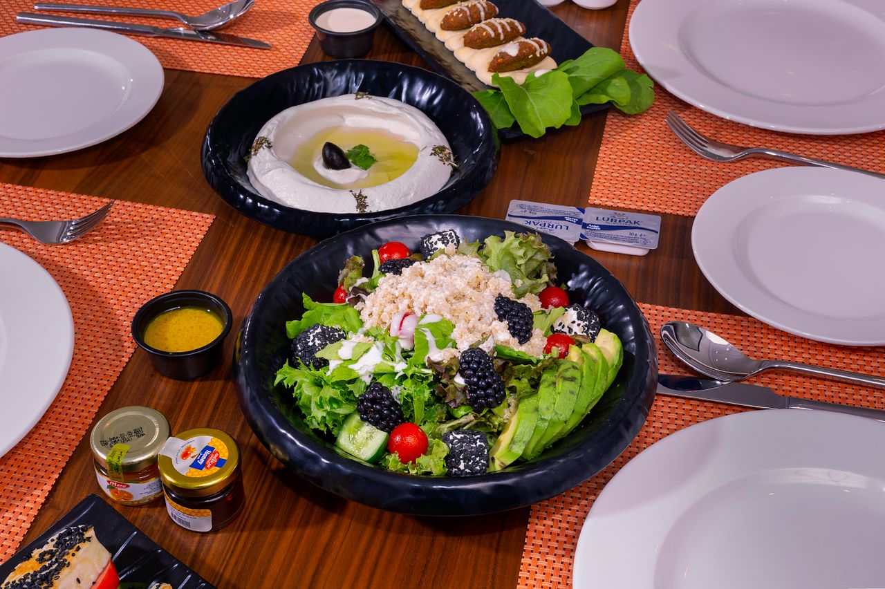 A colorful spread of fresh salad and appetizers on a dining table, ideal for healthy lifestyle themes.